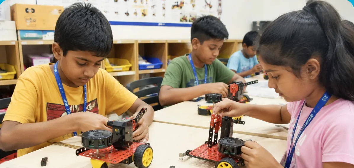 Students building robots on the classroom floor